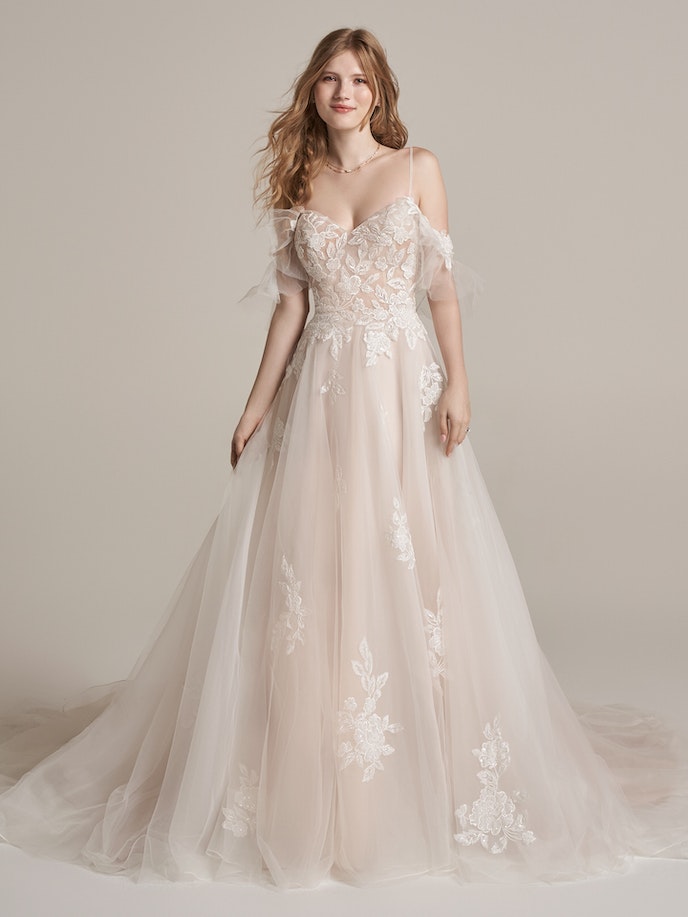 Kalina Wedding Dress: A stunning off the shoulder wedding dress adorned with delicate lace appliques and layered tulle.