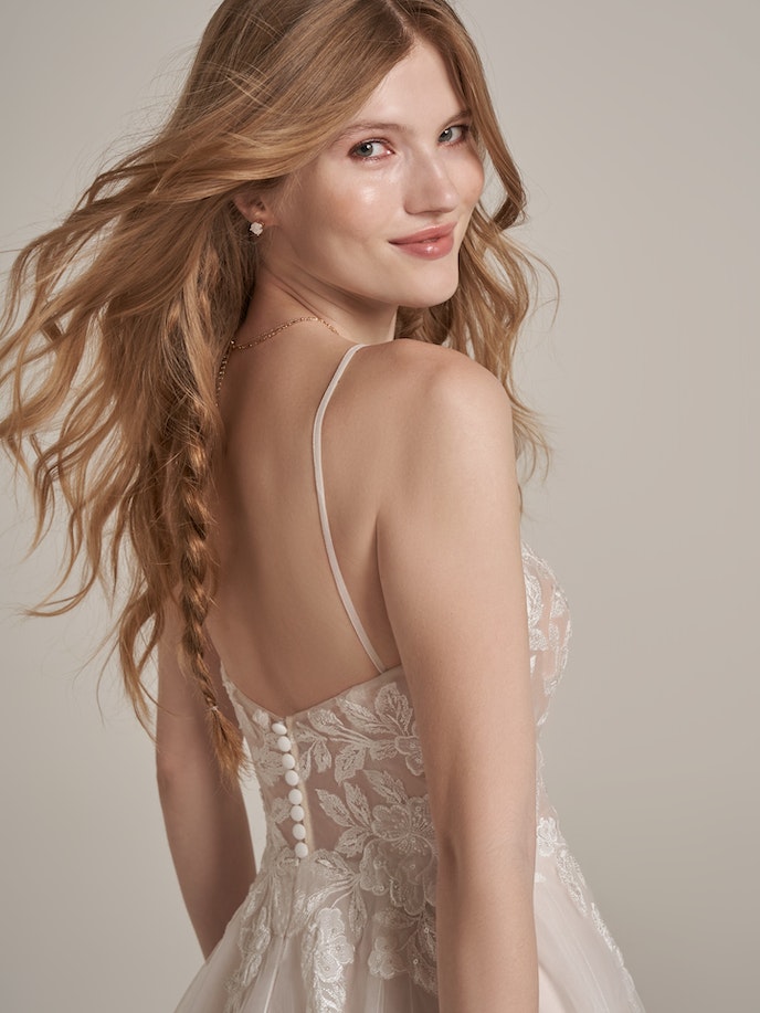 The back view of a woman in a Kalina wedding dress.