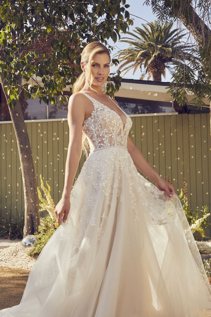 A beautiful bride in a white wedding dress with lilac accents.
