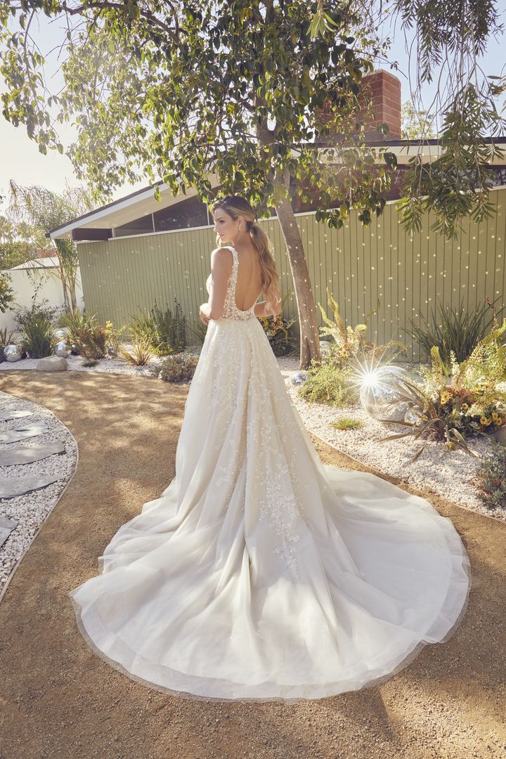 A lilac bride in a wedding dress standing in a garden.